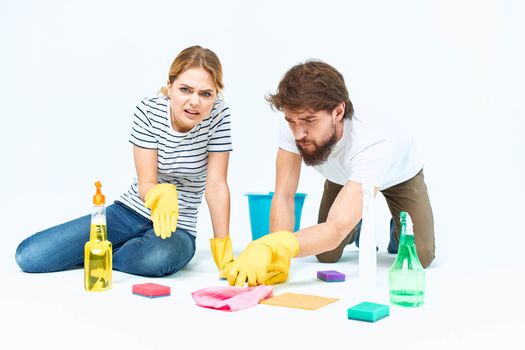 Young couple wash floors at home interior light background lifestyle. High quality photo