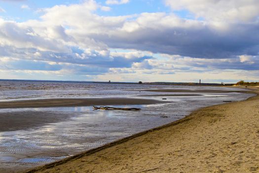 Seascape of sea water and beach, sand and clouds , horizon in Estonia.