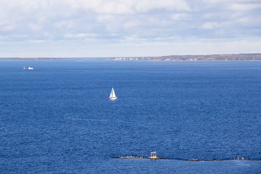 Baltic sea seascape, blue horizon, clouds and boats in Tallinn, Estonia.