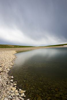 Alpine mountain lake landscape and view, snow and clouds in Javakheti, Georgia