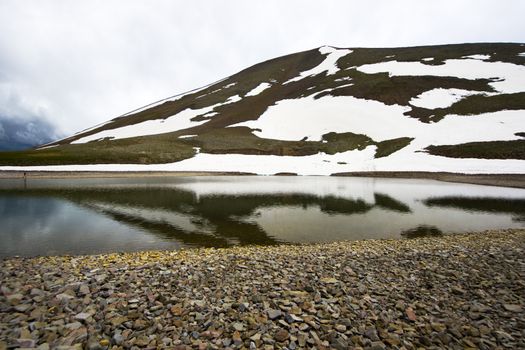 Alpine mountain lake landscape and view, snow and clouds in Javakheti, Georgia