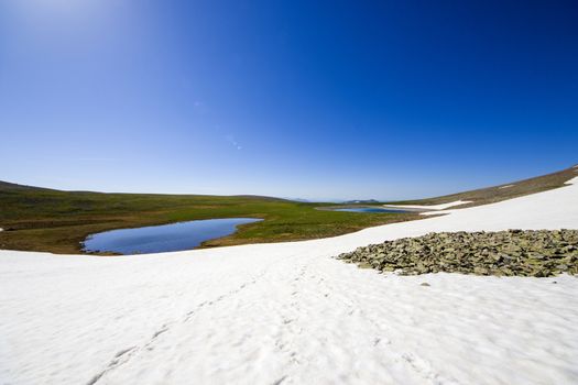 Alpine mountain lake landscape and view, snow and clouds in Javakheti, Georgia