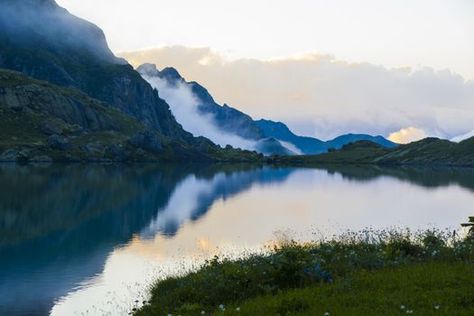 Mountain lake and fog, misty lake, amazing landscape and view of alpine lake Okhrotskhali in the Svaneti, Georgia