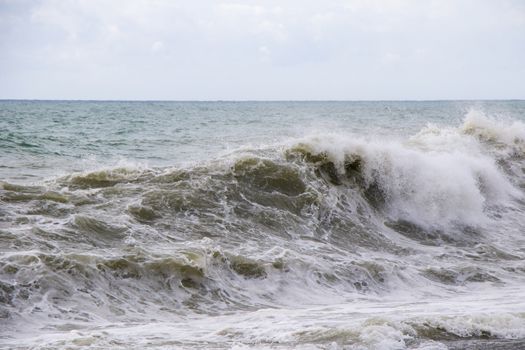 Stormy weather, waves and splashes in Batumi, Georgia. Stormy Black sea. Water background.