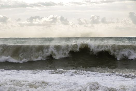 Stormy weather, waves and splashes in Batumi, Georgia. Stormy Black sea. Water background.