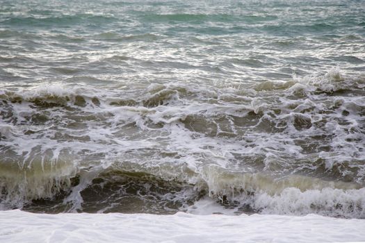 Stormy weather, waves and splashes in Batumi, Georgia. Stormy Black sea. Water background.