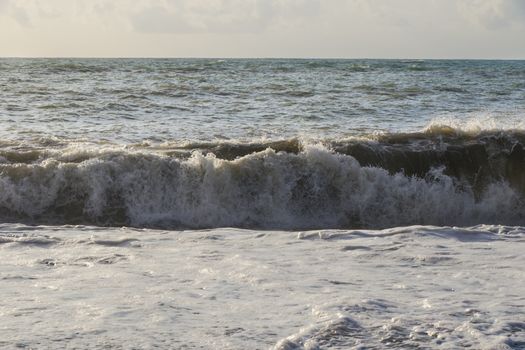 Stormy weather, waves and splashes in Batumi, Georgia. Stormy Black sea. Water background.