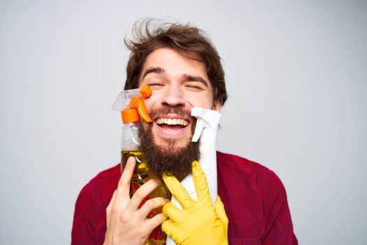 cheerful man with detergent in hands rendering of services cropped view close-up. High quality photo