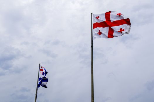 Flag of Adjara and Georgia on the sky background. Georgian flag.