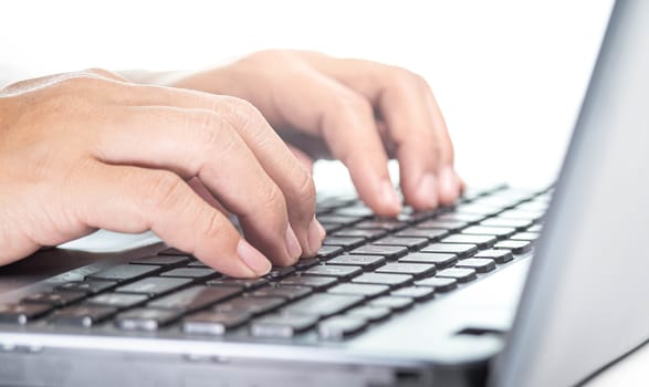 Close up of female hand typing on laptop to work.