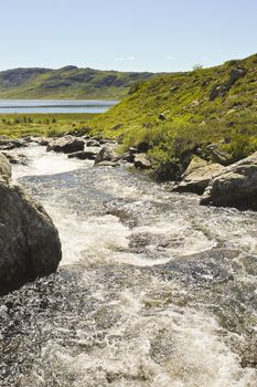 Beautiful Storebottåne river flows into the vavatn lake. Summer landscape in Hemsedal, Buskerud, Norway.