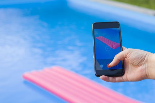 Take photo and video of swimming pool and pink mattress, summertime and empty pool, vacation and holiday, water background. Colorful summer background shooting scene.