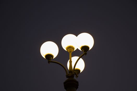 Street light and streetlamp close-up, on the blue background, Night time in Vilnius, Lithuania