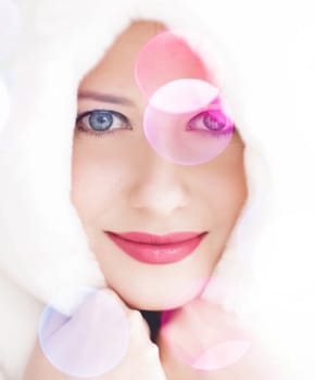 Merry Christmas portrait of smiling young woman wearing fluffy white fur coat, luxury beauty and happy holidays