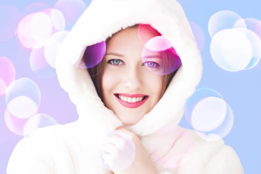 Merry Christmas portrait of smiling young woman wearing fluffy white fur coat, luxury beauty and happy holidays