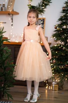 Little girl in princess dress celebrates christmas. Christmas magic fairy tale. Happy childhood.