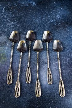 Silverware, silver vintage spoon background, spoon set on the dark background
