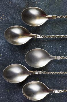 Silverware, silver vintage spoon background, spoon set on the dark background