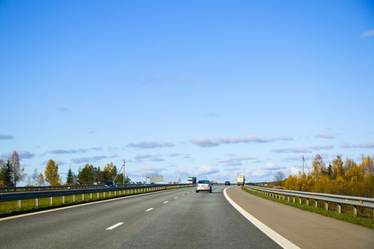 Highway, autobahn and road landscape. Automobile, cars and vehicles. Blue sky and sunny day. European autobahn. Nature and urban together.