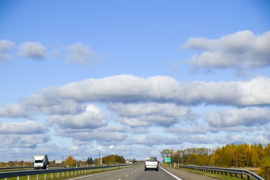 Highway, autobahn and road landscape. Automobile, cars and vehicles. Blue sky and sunny day. European autobahn. Nature and urban together.