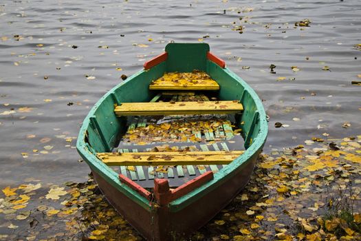 Old wooden boats near the beach of Trakai Gavle lake , Lithuania. Autumn and fall time.