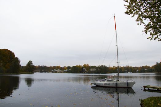 Old wooden boats near the beach of Trakai Gavle lake , Lithuania. Autumn and fall time.