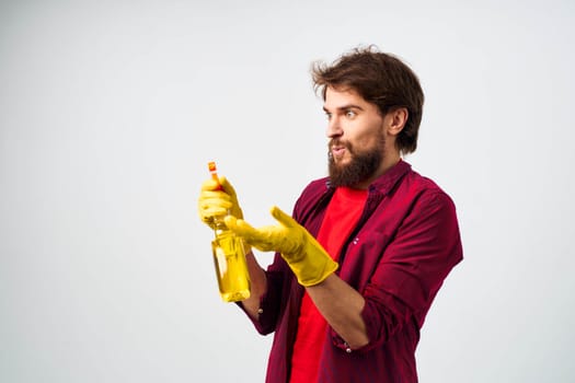 emotional man wearing rubber gloves detergent cleaning housework cropped view. High quality photo