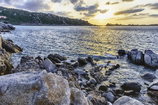 Scenic sunset over the sea among the beautiful granite rocks of Santa Teresa Gallura, northern Sardinia, Italy