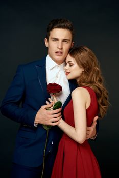 luxury couple hug romance relationship rose over dark isolated background. High quality photo