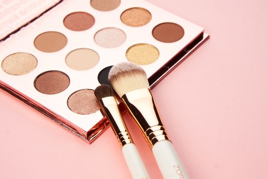 eyeshadow makeup brushes collection professional cosmetics accessories on pink background. High quality photo