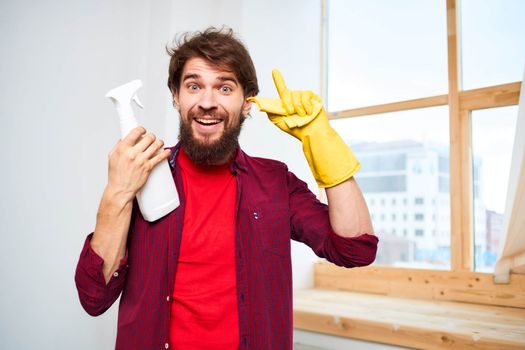 Cheerful man cleaning detergent homework hygiene interior. High quality photo