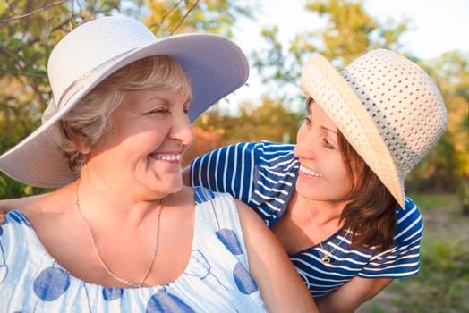 Happy daughter embracing her smiling mother.