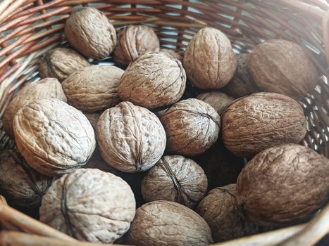 A group of walnuts in a wooden basket. Healthy eating lifestyle