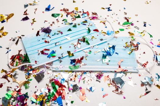 Facemask droped on flor with confetti after celebration new year 2021 party background stock image