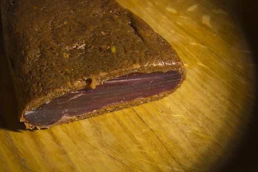 Piece of smoked meat on wooden board