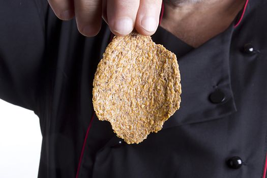 Rye chips in the hand of a male chef