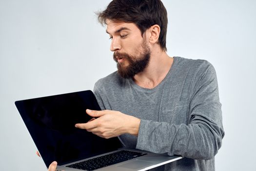 A man in a gray sweater with a laptop hands lifestyle technology communication internet work. High quality photo