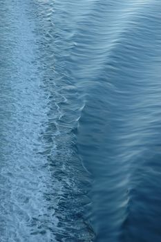 white backwash of a ferry crossing ocean