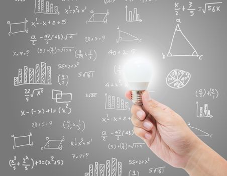 hand hold lightbulb with brainstorm creative idea on math formula background, knowledge and innovation with chart for analysis, success concept.