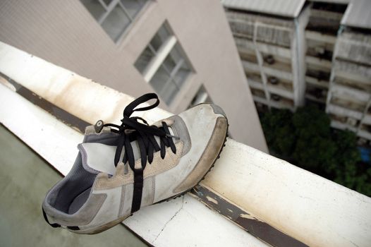 leftover shoe at the edge of a building roof