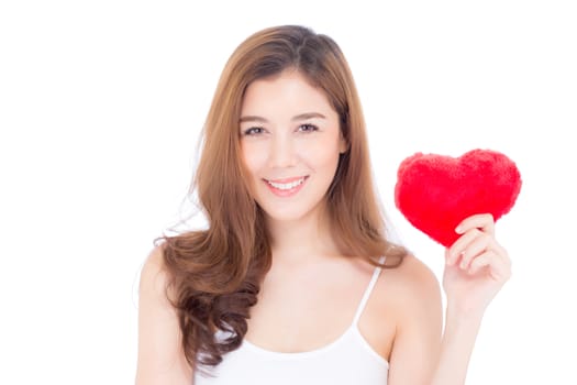 Portrait of beautiful asian young woman holding red heart shape pillow and smile isolated on white background, valentines day, holiday concept.