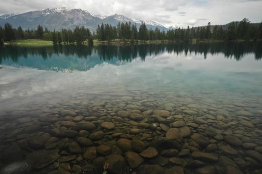 clear lake and snow mountain range