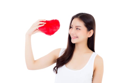 Portrait of beautiful asian young woman holding red heart shape pillow and smile isolated on white background, valentines day, holiday concept.