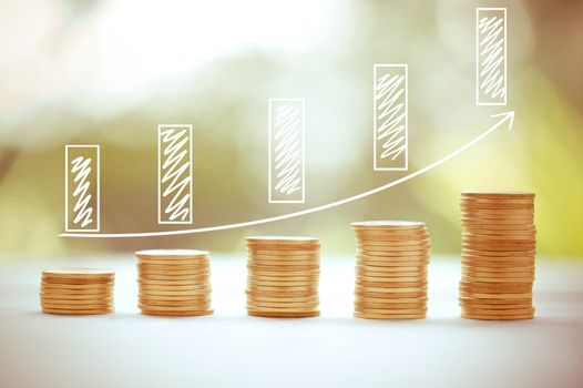 Money coins stack growing graph bank on nature background, saving finance and chart for growing success, business concept.
