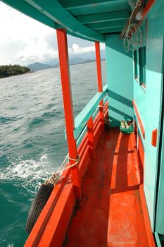 Colourful boat to sail sunny Andaman Sea in Thailand