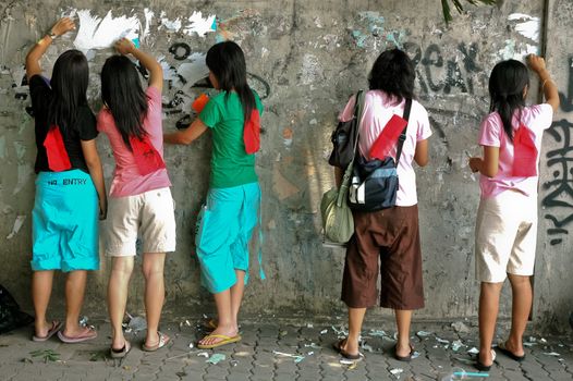 teenagers group clean graffiti on old wall