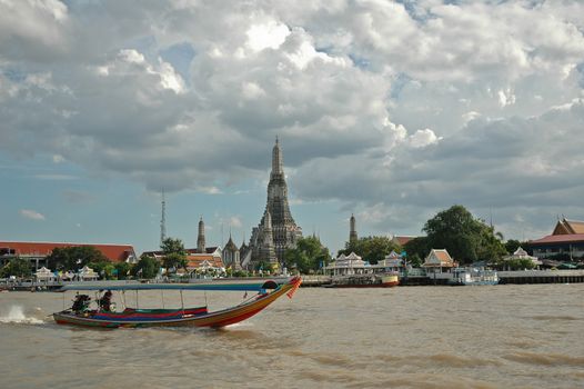 Tourist long tail boat on Bangkok river and Dawn temple