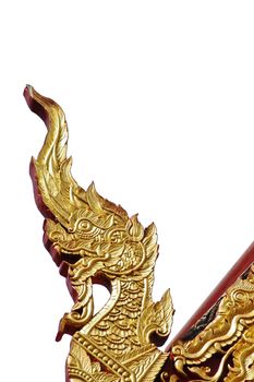 Golden naga Thai dragon ornament on temple roof isolated