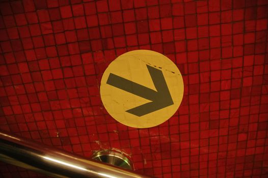 Yellow sign on red backgrond in Hong Kong subway