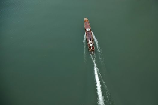 Top perspective of Thai ancient wooden speed boat on emerlad river